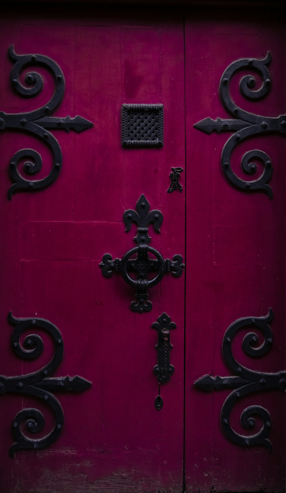 a close up of a red door with a decorative design