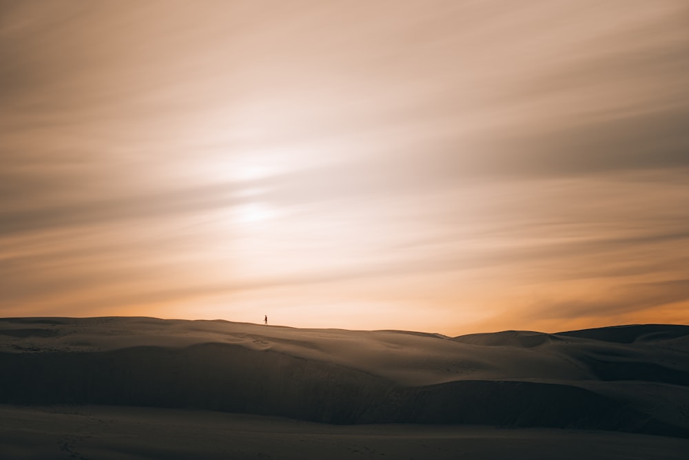 a person standing on top of a snow covered slope