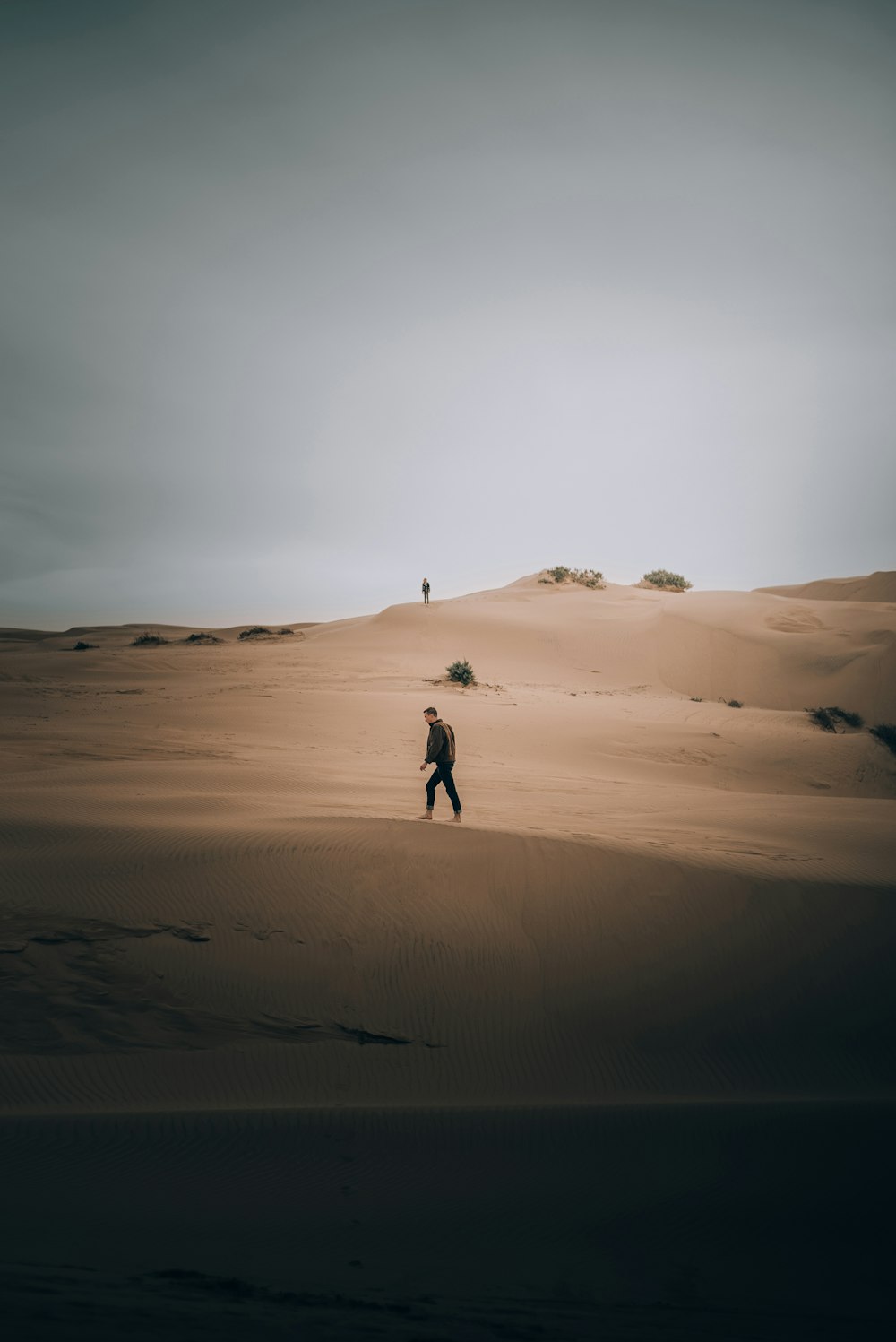 a man standing in the middle of a desert