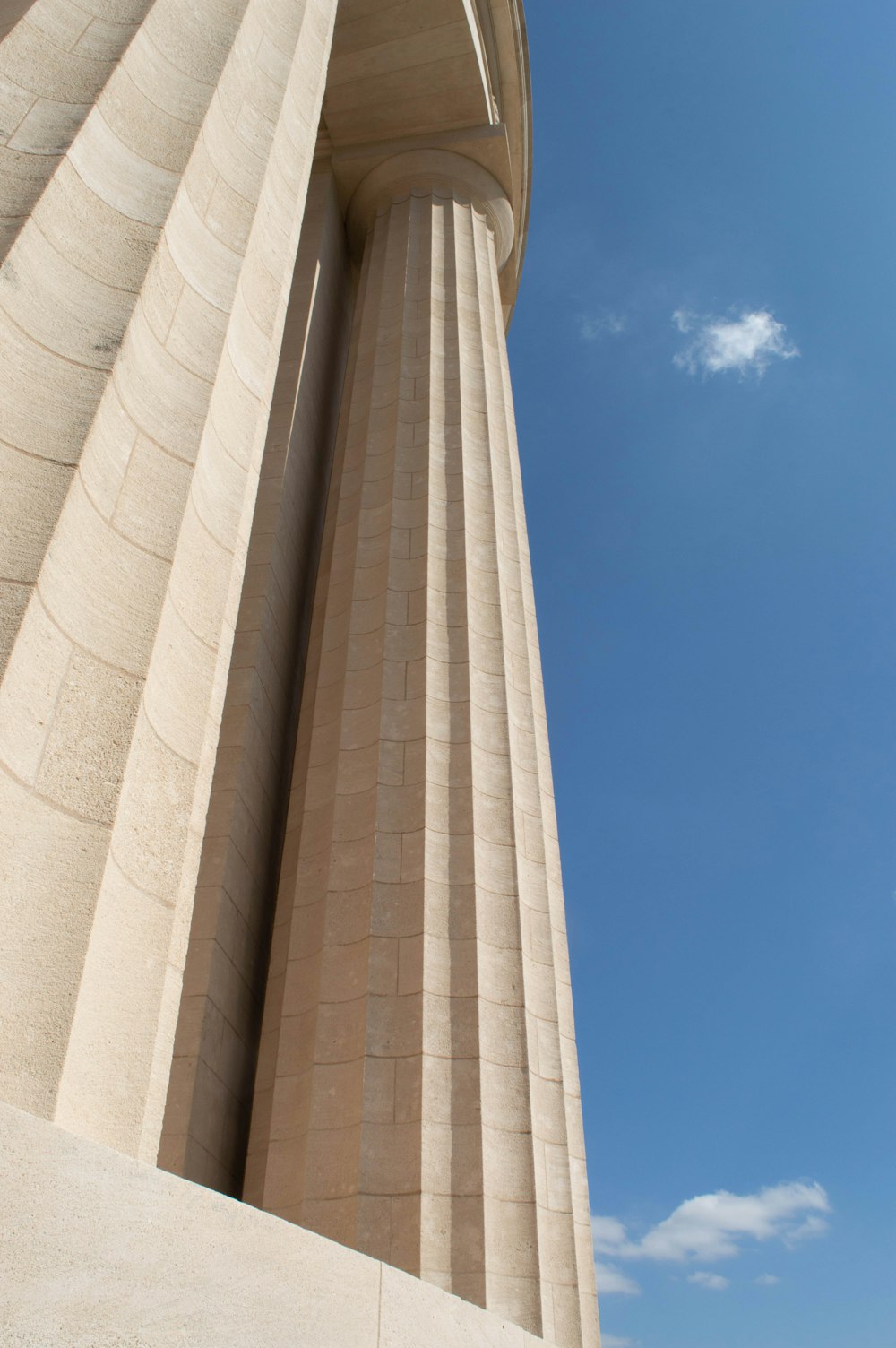 a tall building with a sky in the background