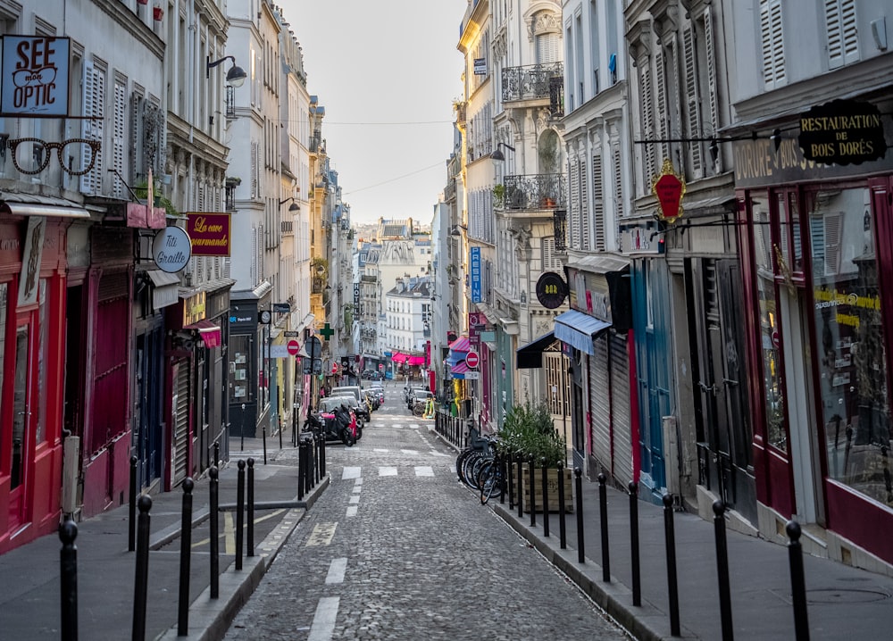 a narrow city street lined with tall buildings