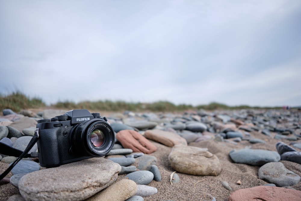 a camera sitting on top of a pile of rocks