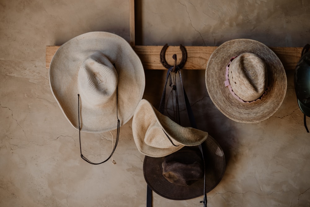 a couple of hats are hanging on a wall