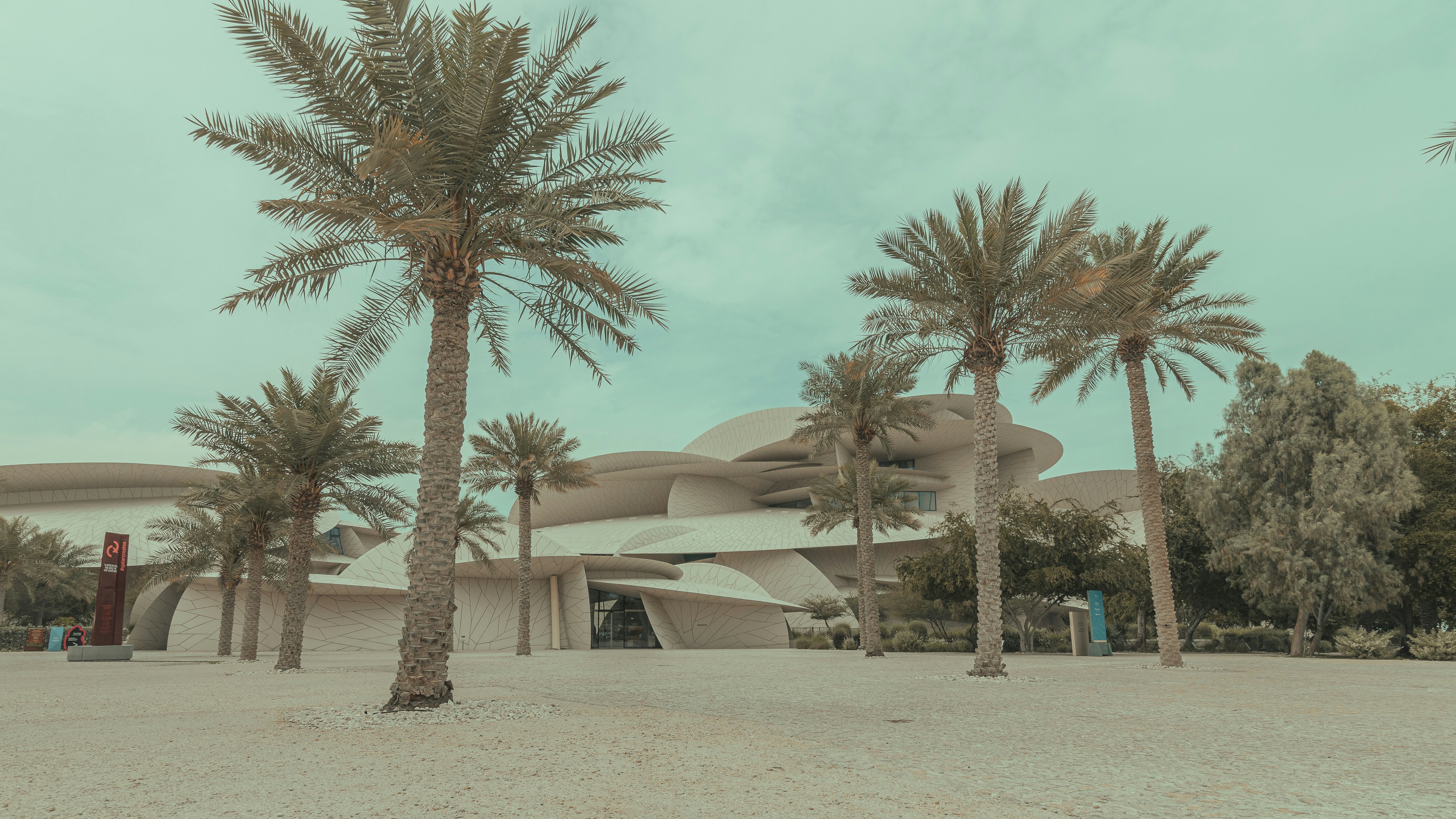 a building with palm trees in front of it