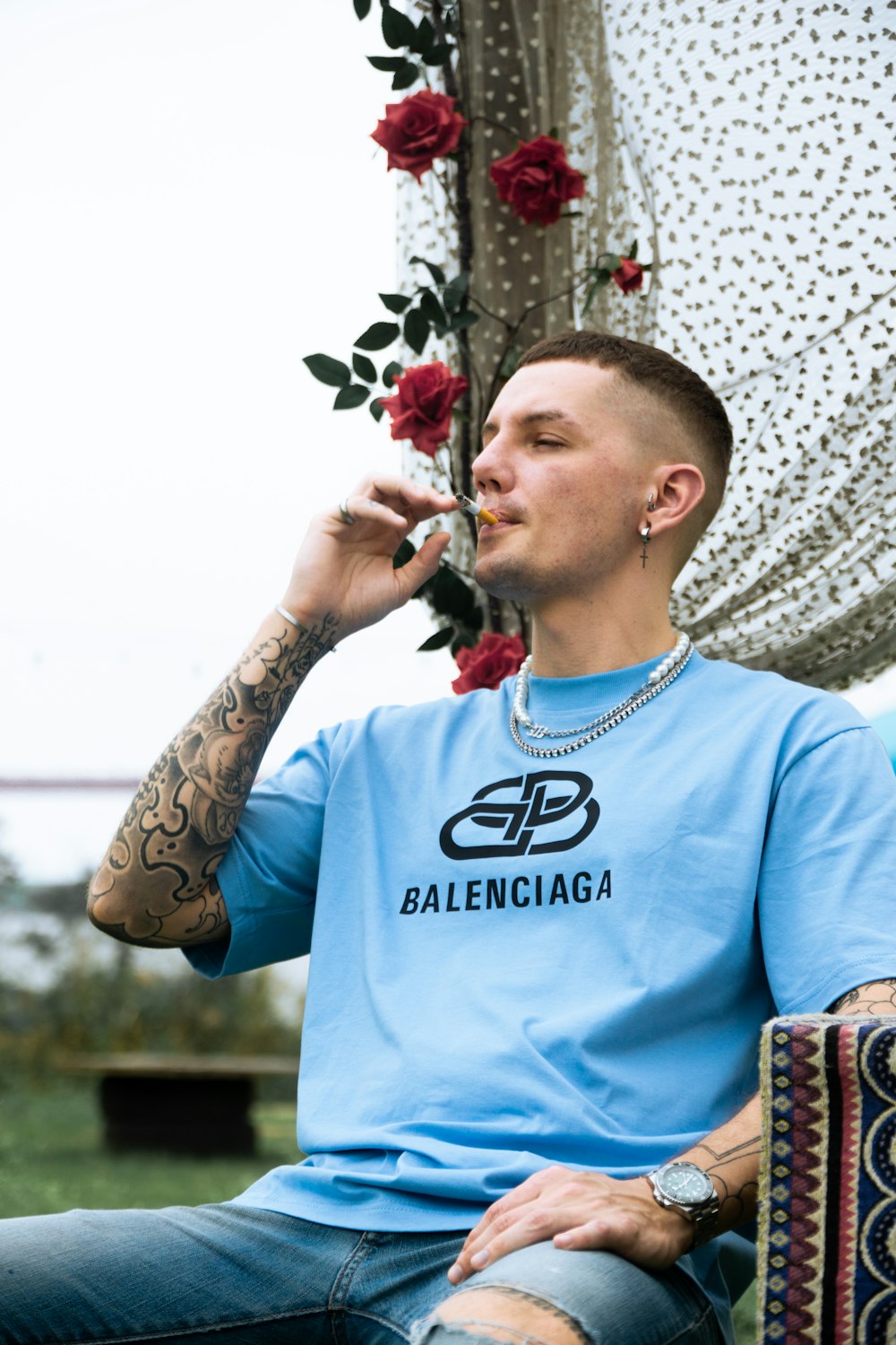 a man sitting in a chair smoking a cigarette