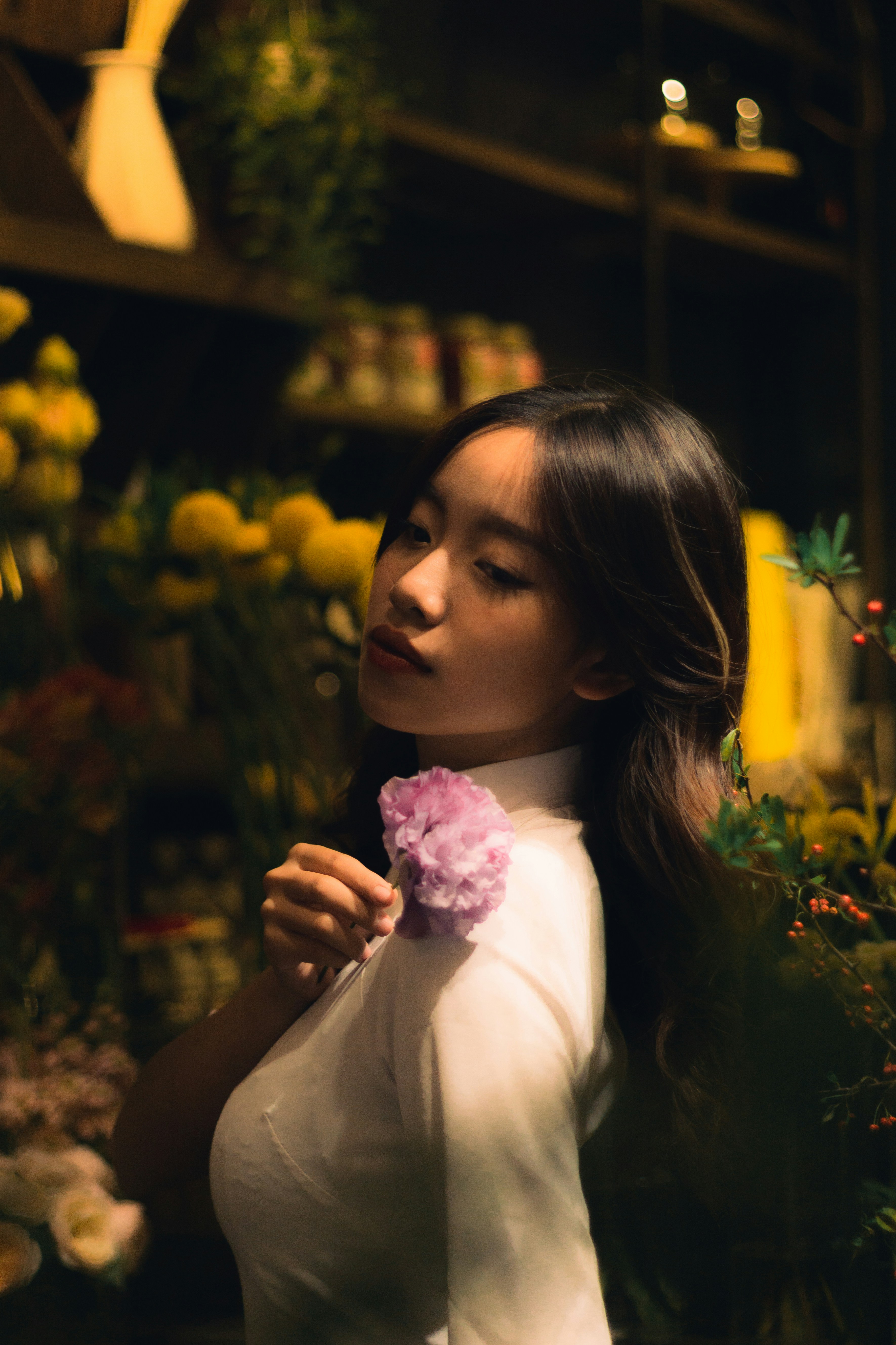 A woman holding a flower in her right hand photo – Free Photography ...