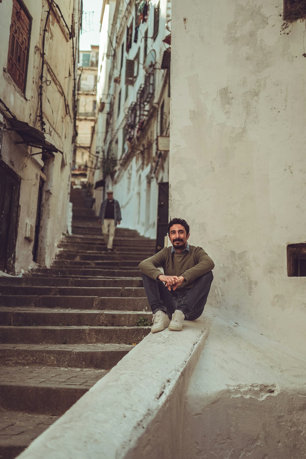 a man is sitting on a set of stairs