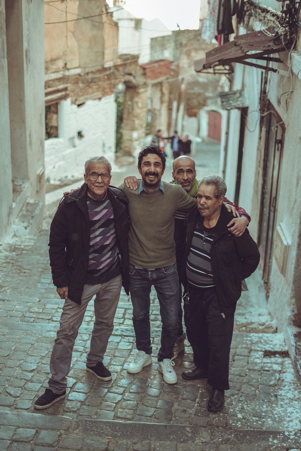 a group of men standing next to each other on a street