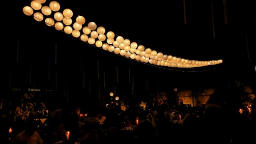 Guests enjoying spicy dishes under warm, ember-lit lanterns with Mayan patterns glowing softly.