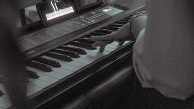 A student playing keyboard during an online music lesson