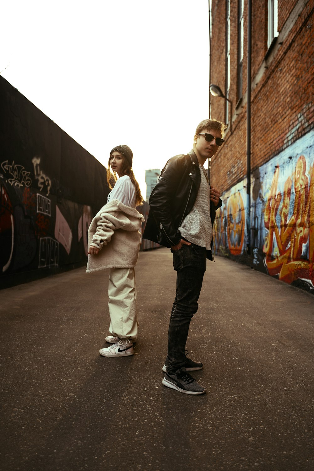 a man and a woman are standing in the street