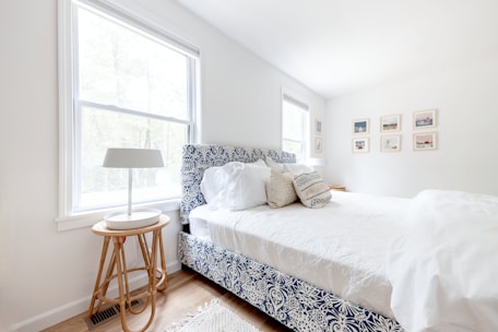 A charming coastal-inspired bedroom with light blues and natural textures.