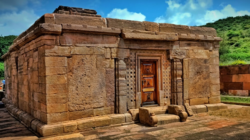 a stone building with a wooden door and window