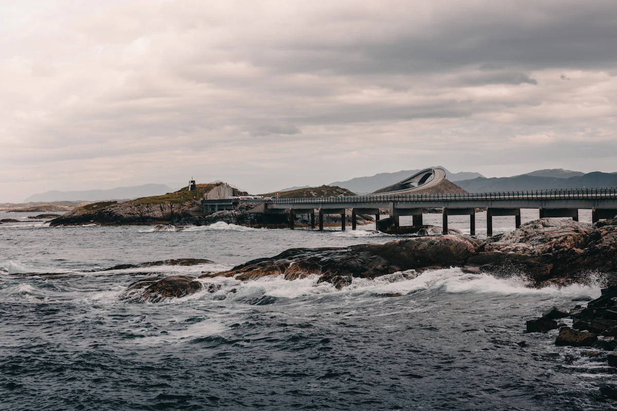 Dramatic bridge on Norway's Atlantic Road curving over open water under a moody sky
