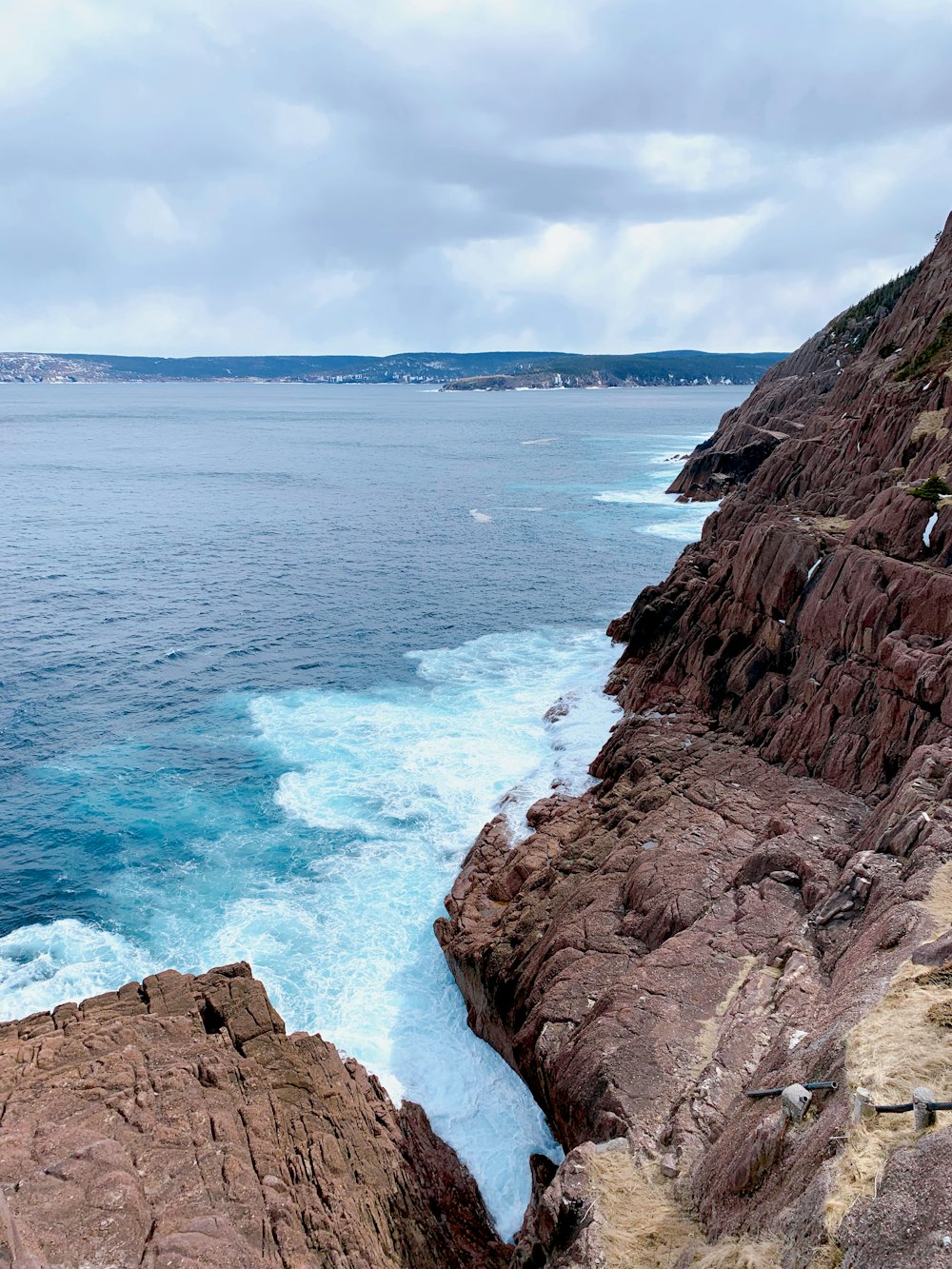 a view of the ocean from a rocky cliff