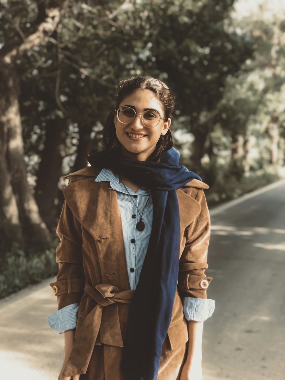 a woman standing on the side of a road