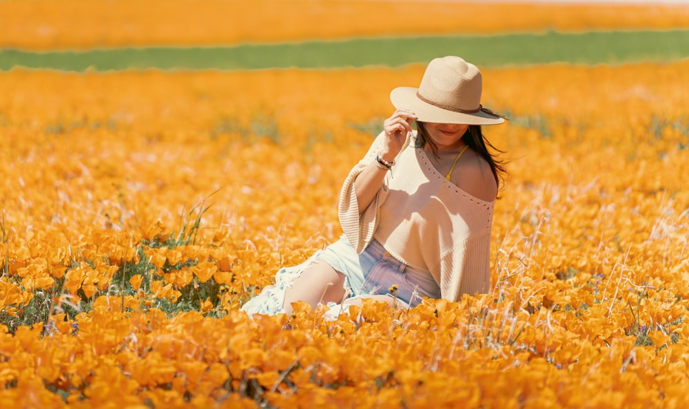 a woman sitting in a field of yellow flowers