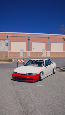 Side view of a lowered sports car with custom wheels on a city street.