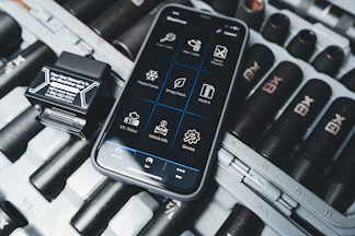 a cell phone sitting on top of a keyboard