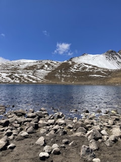A serene mountain landscape with a clear blue lake