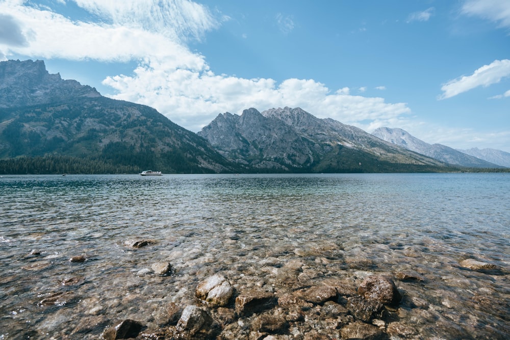 a body of water with mountains in the background