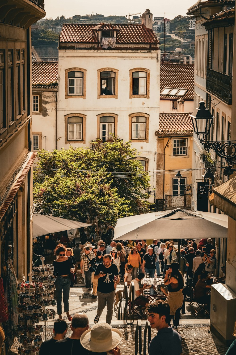 a crowd of people walking down a street next to tall buildings