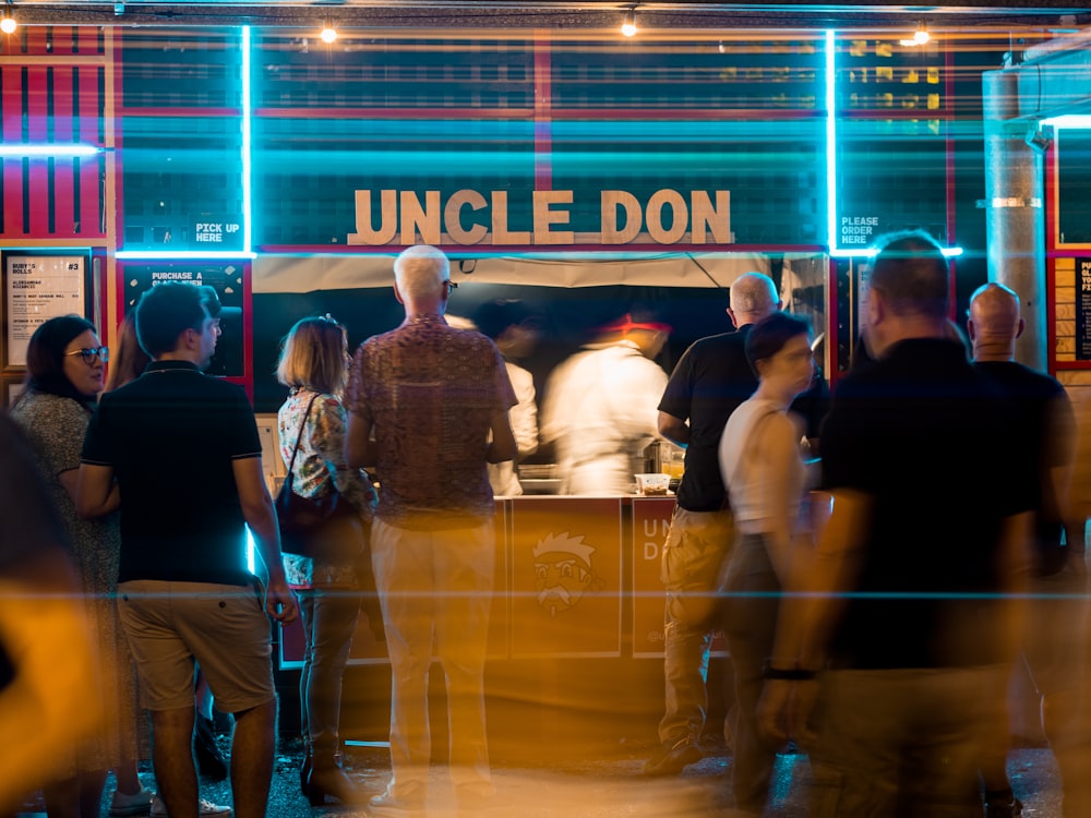 a group of people standing around a bar