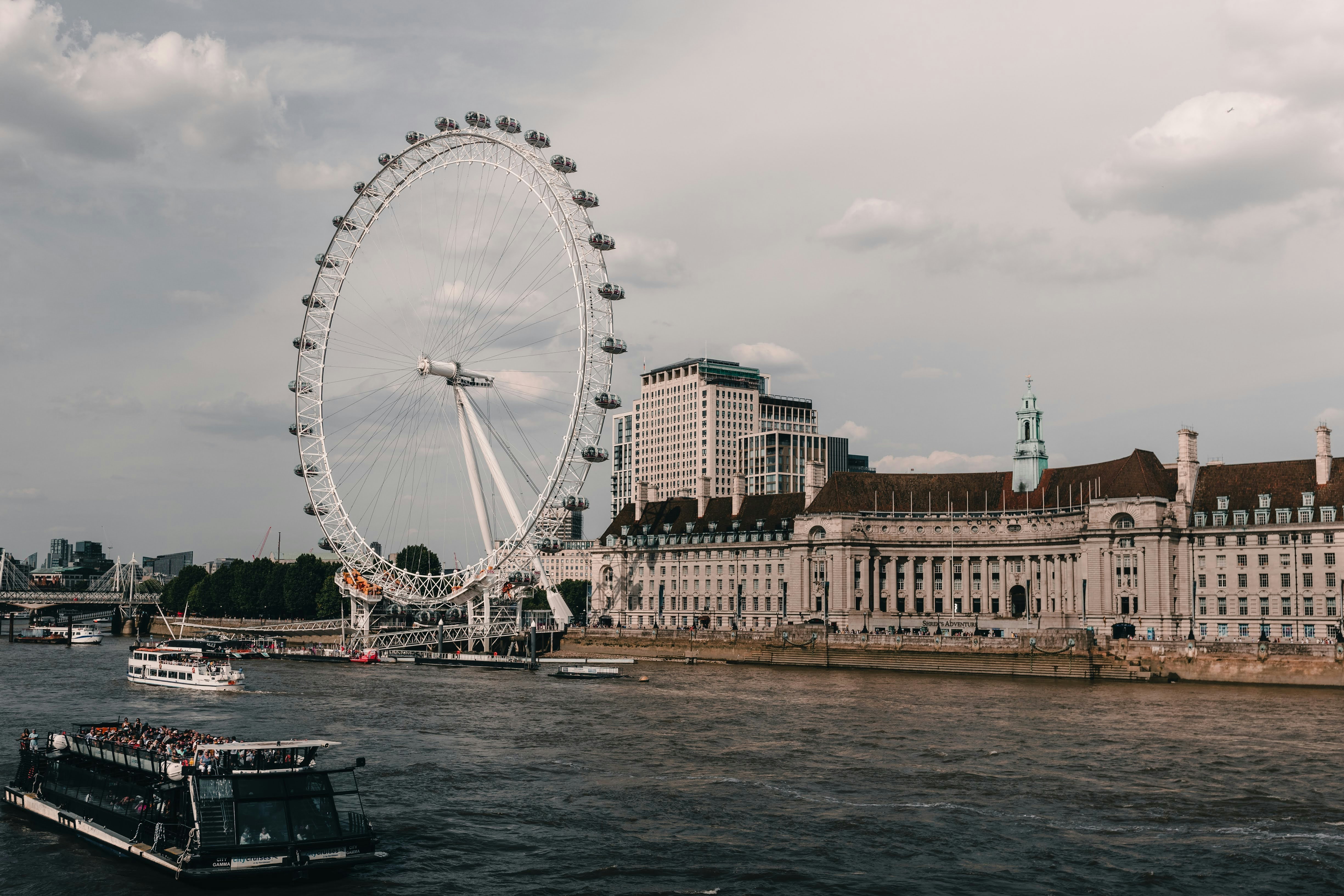 a large ferris wheel in the middle of a body of water, 