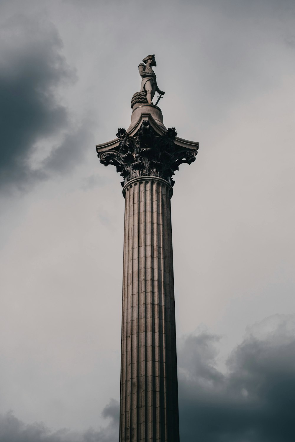 a tall tower with a statue on top of it