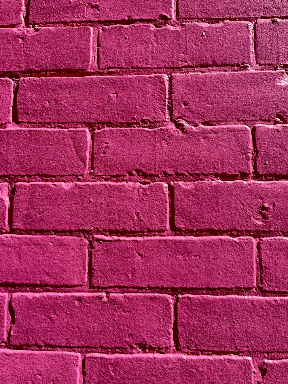 a pink brick wall painted in a very vibrant shade