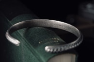 Elegant bracelet wrapped around a vintage book, highlighting fine details and craftsmanship.