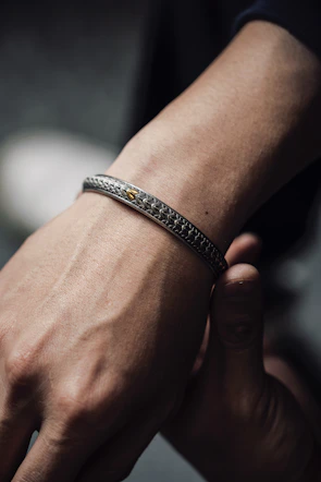 Elegant lace bracelet displayed with soft golden light highlighting its delicate details.