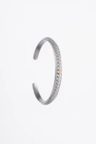 A vibrant assortment of silver bracelets with intricate patterns.