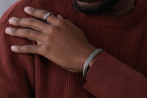 Close-up of rose gold accessories paired with a soft cashmere sweater, highlighting fabric texture and detail.