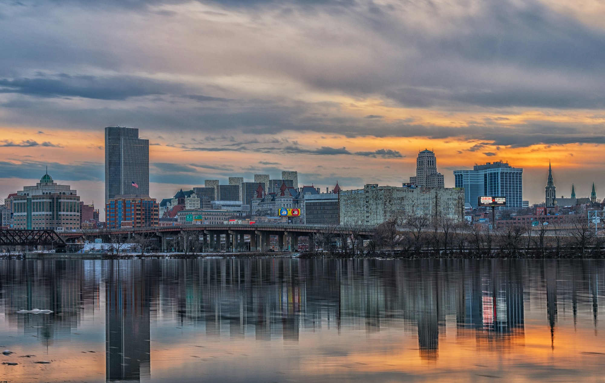 a large body of water with a city in the background