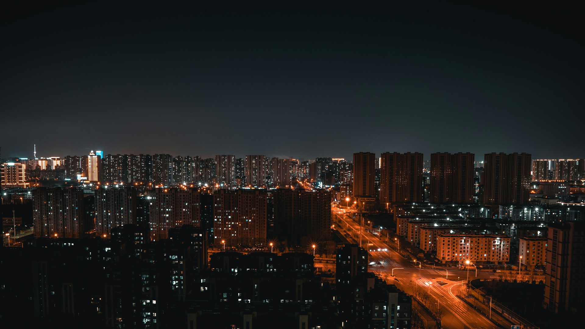 a view of a city at night from the top of a building