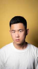 a man in a white shirt looking at the camera