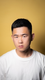 a man in a white shirt looking at the camera