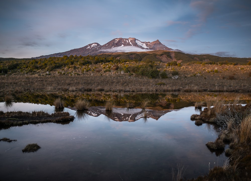 a mountain with a reflection in the water