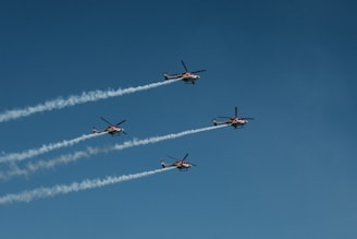 A fleet of UAVs coordinating in formation over a disaster-stricken area.