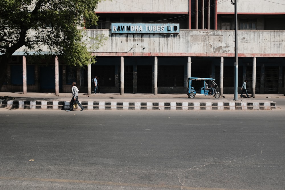 a man walking down the street in front of a building