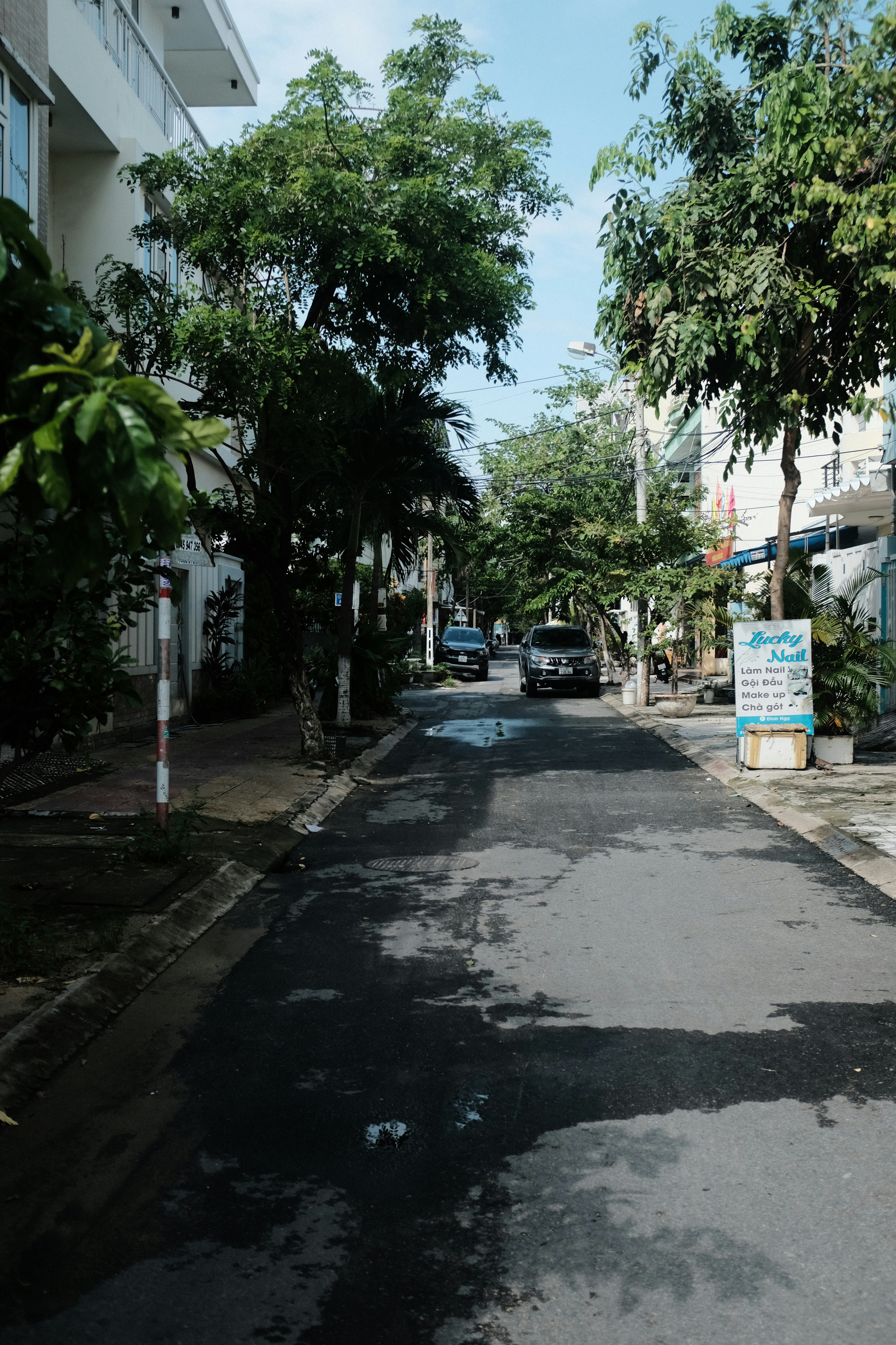 a street with a few cars parked on the side of it