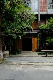 Photo of a modern apartment building entrance with greenery.