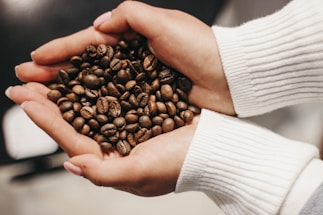 A warm handshake between a Mexican coffee farmer and a coffee roaster in a sunlit plantation