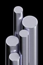 A display of stainless steel rods and bars arranged by size and finish.