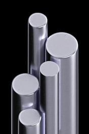 a group of three metal cylinders sitting next to each other