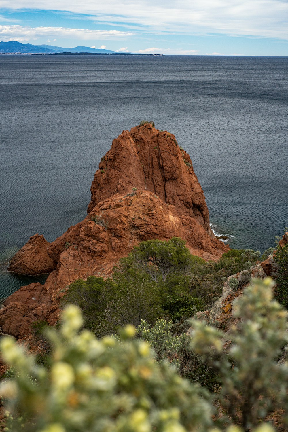 a large rock in the middle of a body of water