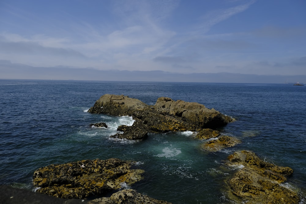 a body of water with rocks in the middle of it