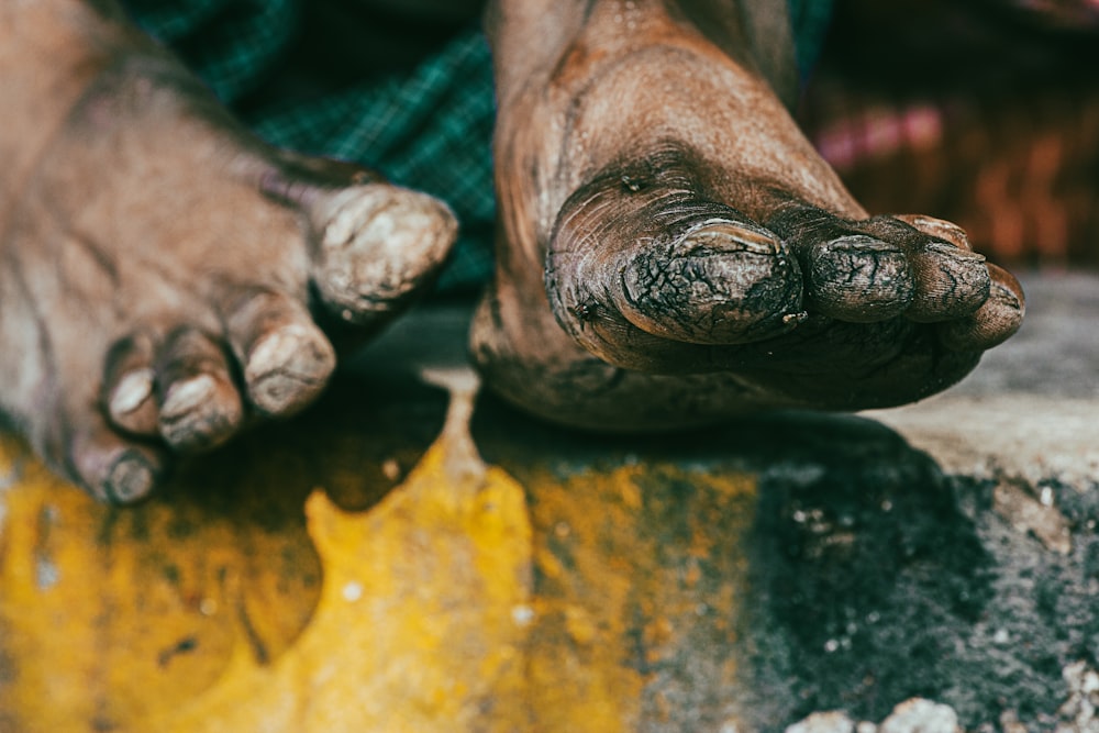 a close up of a person's foot with mud on it