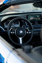 the interior of a car with a steering wheel and dashboard